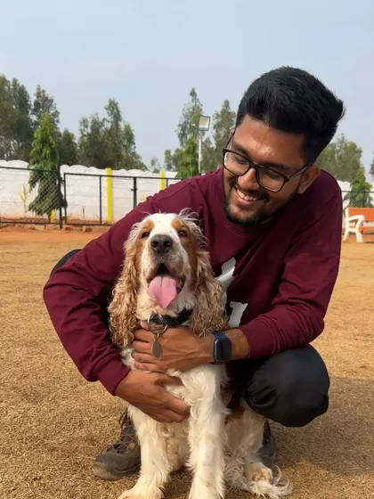 The connection between a trainer and a dog is built on trust and mutual respect. This smile says it all. A happy dog is a sign of a successful training relationship.