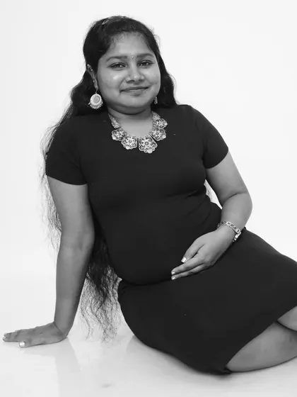 A relaxed and confident seated pose in black and white. This style of maternity portrait is modern, clean, and beautifully highlights the mother-to-be.