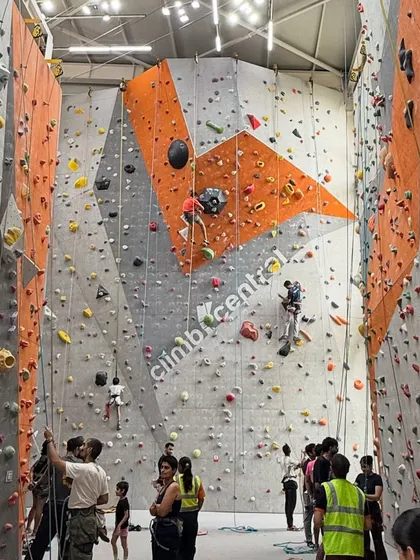 This is the heart of our community. A wide view of our gym on a busy day shows climbers of all ages and skill levels tackling different routes, supporting each other, and sharing the space.