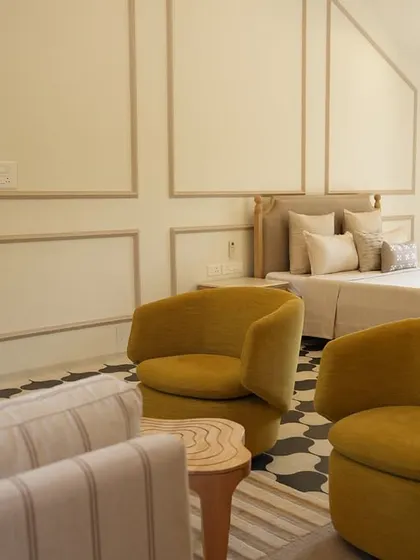 In this Alibaug villa, the master bedroom is a sanctuary of calm. I used a palette of soft neutrals and earthy textures, accented by pops of mustard yellow, to create a space that feels both expansive and deeply restful, a true escape from the city.