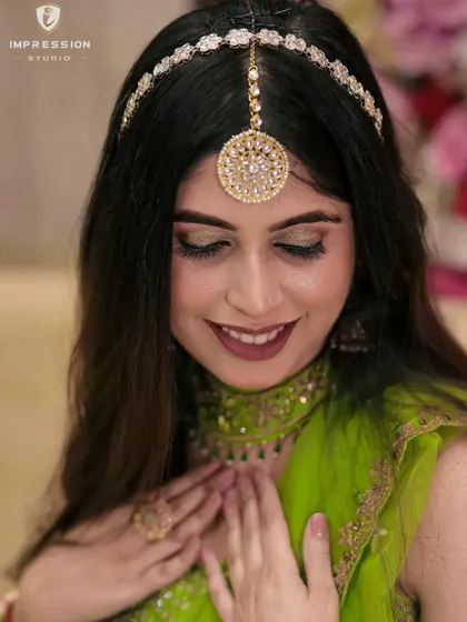 Capturing the radiant glow of a bride-to-be, as she smiles with anticipation and shyness during her mehendi ceremony.