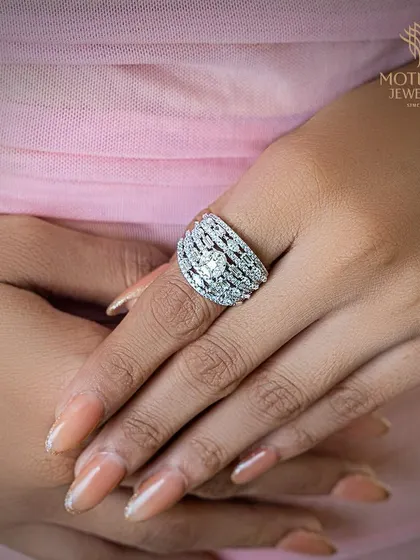 This wide, domed ring is entirely paved with diamonds, creating an effect of pure brilliance. It is a bold and glamorous piece designed to make a powerful statement.