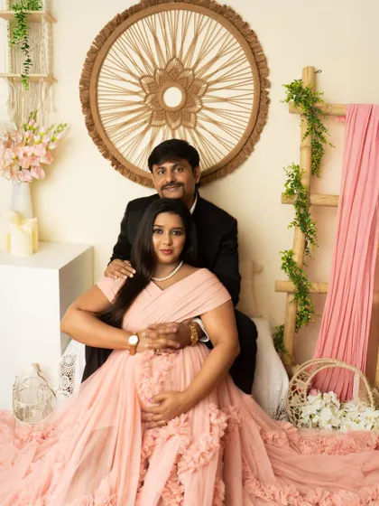 A classic seated couple's portrait in our versatile boho setup. The soft pink gown and neutral decor create a warm and inviting image.
