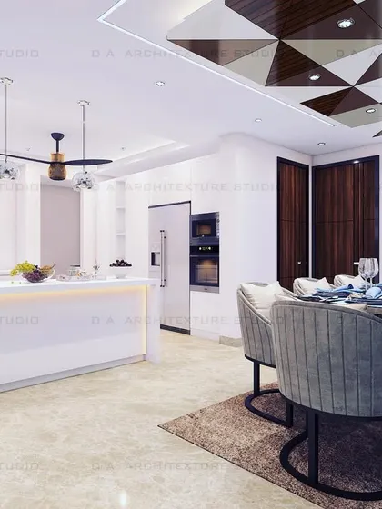 A bright and open common area where the dining space is defined by a striking geometric-patterned false ceiling. This feature adds visual interest without closing off the room.