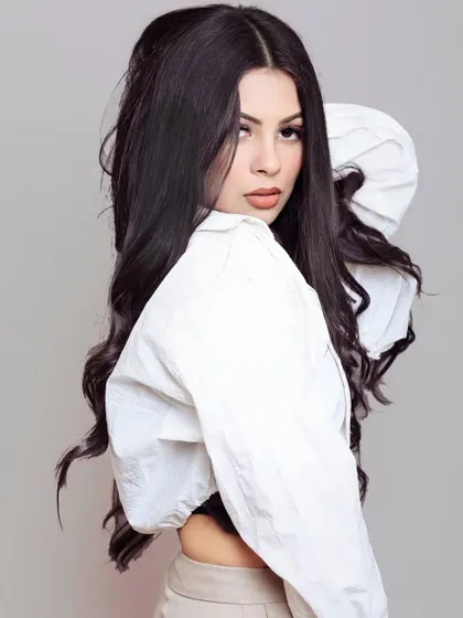 A three-quarter shot of a model in a white crop jacket, demonstrating a casual and trendy look for a fashion brand's social media.