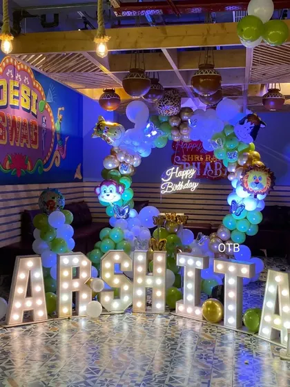 The full setup for Harshita's jungle-themed party, complete with large light-up letters spelling her name. This shows how we can personalize any theme to make it extra special.