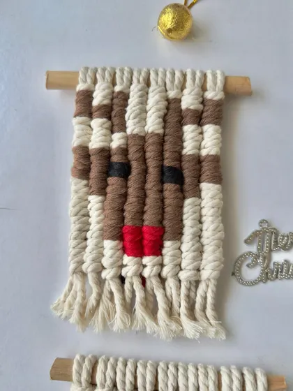 A close-up of the macrame reindeer wall hanging, complete with a little red nose.