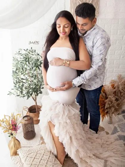 This couple's portrait showcases the beautiful ruffled gown and the loving way the dad to be holds the baby bump. A truly beautiful memory.