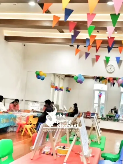 An overview of the art party setup, showing the various activity stations with easels and art supplies, all ready for the little artists to arrive and get creative.