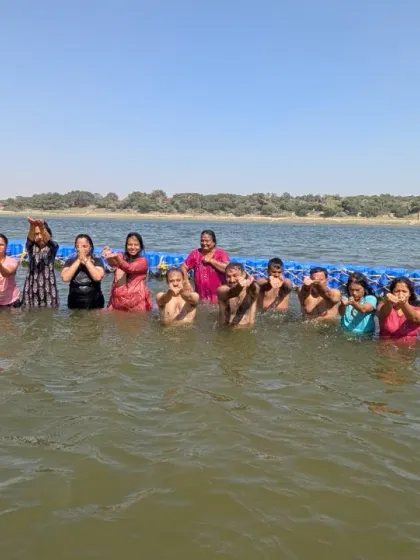 Participants taking a sacred dip in the holy river at Prayagraj, an essential part of the Kumbh Mela experience.
