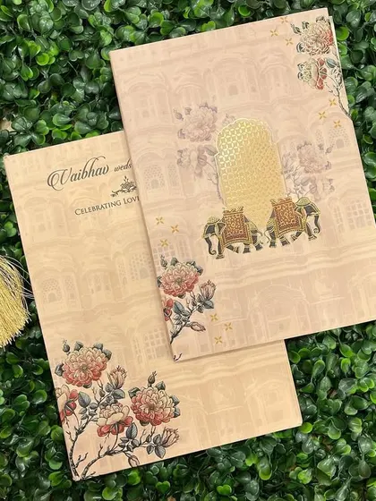 A closer look at our invitation with 'palki' and elephant motifs, printed on a textured paper that adds to its vintage charm.
