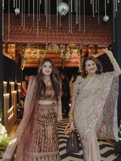 Guests making a grand entrance through a glamorous, shimmering walkway.