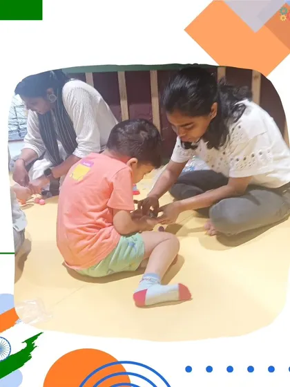 An instructor helps a young child connect the circuit for their light-up card. We use conductive play dough to make the concept of electricity safe and easy to grasp.
