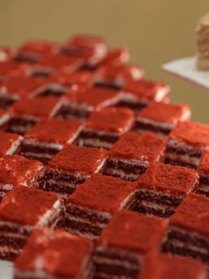 A duplicate of image 133, showing our precisely cut red velvet petit fours. The striking visual appeal of this dessert makes it a standout on any buffet.
