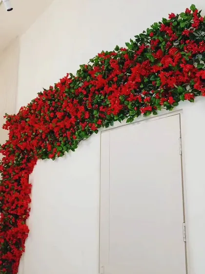 Another view of the artificial red bougainvillea garland, shown here framing the top of a door. It's a simple way to add a bold splash of color to any entrance.