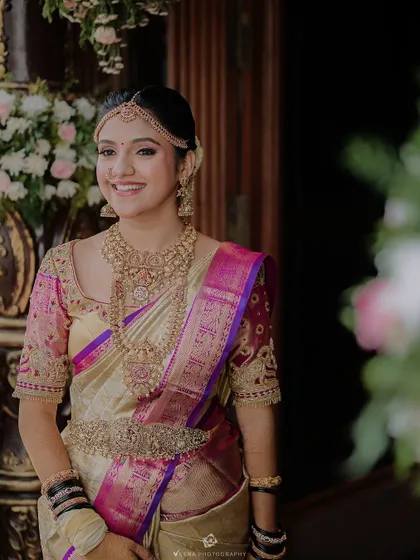 A full shot of a bride in her Kanjeevaram saree. My draping service ensures the rich fabric and borders are displayed beautifully.