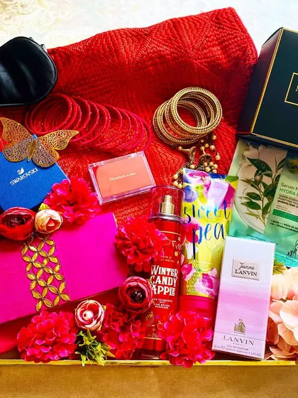 My Karwa Chauth Edit is a tray full of pampering and luxury for that special woman. This arrangement includes a Swarovski piece, premium cosmetics, a silk eye mask, and other indulgent treats in a vibrant red and pink theme.