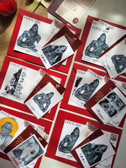 A scattered display of my various postcard designs, showing the variety of spiritual figures available for custom gifting.