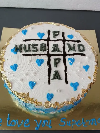 A fun tic-tac-toe themed cake celebrating a man who is a great Husband, Father, and Papa.