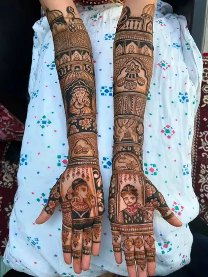 A classic portrait design with the bride and groom on separate palms, each framed beautifully. The arms feature a Ganesha motif and other auspicious symbols.