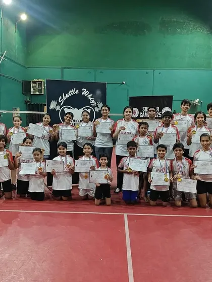 A proud group of our young players and coaches at the Santacruz East branch, showcasing their certificates and medals from a recent event.