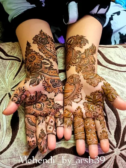 A beautiful example of a traditional bridal design with prominent peacock and floral motifs.