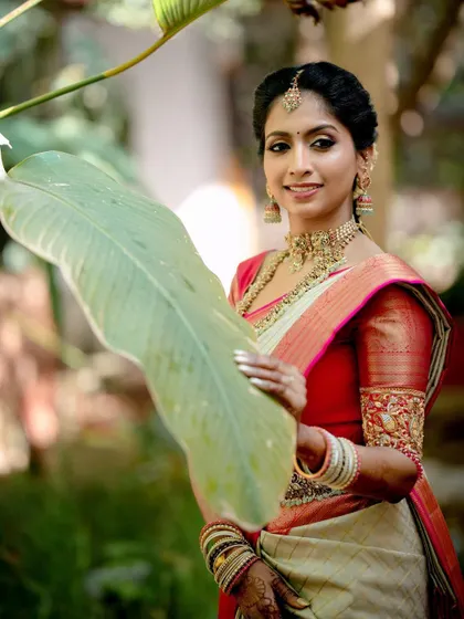 A close-up of Sushma's bridal look, highlighting the delicate embroidery on her blouse sleeves.