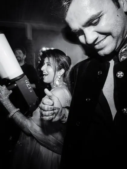 A candid black and white shot of the couple enjoying the party, complete with a CO2 gun for extra fun.