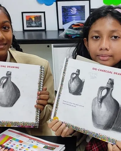Senior students showcase their impressive charcoal drawings, a testament to the advanced artistic skills they develop in our art classes.