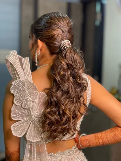 A side view of the messy ponytail, showing its volume and beautiful curly texture.