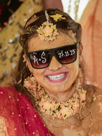 The bride, all smiles and covered in haldi, posing with her custom sunglasses. We love capturing the bride's fun and quirky personality.