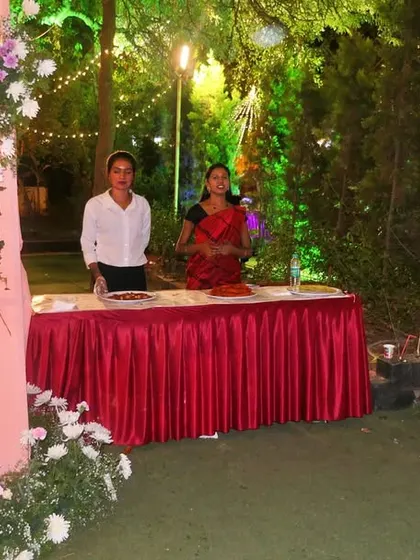 The welcome desk at an outdoor reception. My staff is positioned to greet guests and guide them towards the dining area, ensuring a smooth start to the event.