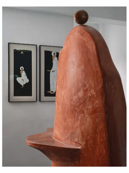The "Melting Candle" wall serves as a sculptural backdrop for other art pieces. Here, it stands behind two beautiful paintings, creating a rich dialogue between different forms of art. It is a prime example of how we layer artistic elements to tell a deeper story.