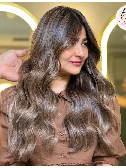 The client looking confident and beautiful with her new ash blonde hair.