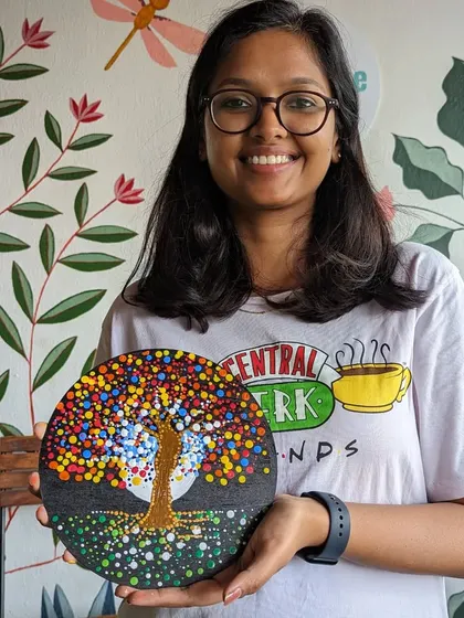 A participant with her stunning dot mandala featuring a tree of life design. The combination of colors and patterns is breathtaking.