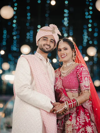 A happy couple portrait against a backdrop of beautiful bokeh lights, creating a magical and celebratory feel for their reception.