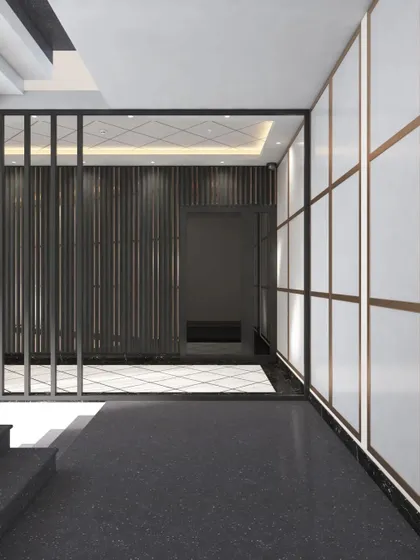 A hallway detail showing the material palette of dark terrazzo flooring, metal screen partitions, and paneled walls. This combination of textures adds depth and sophistication to the office corridors.