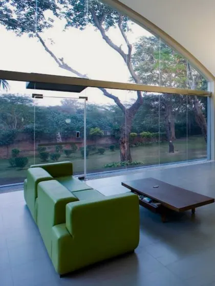 We believe in blurring the line between the built and the natural. By retaining the form of an old industrial shed in Okhla and opening it up with floor-to-ceiling glass, we transformed a forgotten structure into a workplace that breathes. This space is a prime example of our commitment to adaptive reuse and biophilic design, creating a seamless connection with the outdoors.