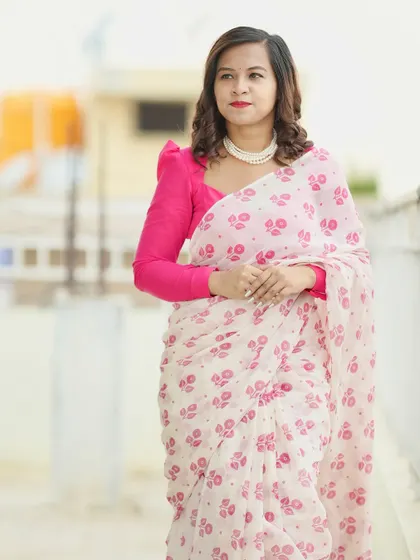A three-quarter shot of the white and pink cotton saree, perfect for a daytime event.