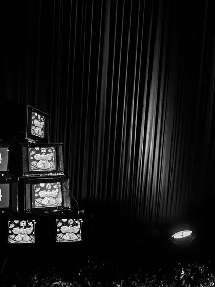 An installation of stacked vintage television sets displaying psychedelic, custom-made visuals. This retro-tech art piece was a major focal point and conversation starter.
