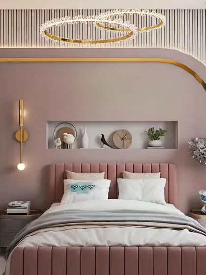 A chic and modern bedroom design with a curved, metallic accent tracing the wall and ceiling. The combination of soft pinks, warm lighting, and custom shelving creates a stylish and personalized space.