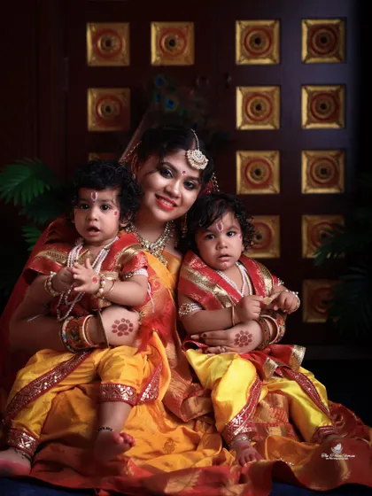 A mother's embrace with her two little Krishnas. This family portrait from a Janmashtami shoot is full of color, tradition, and love.