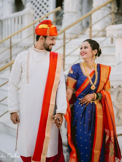 The couple walking hand-in-hand, sharing a loving glance on their wedding day.