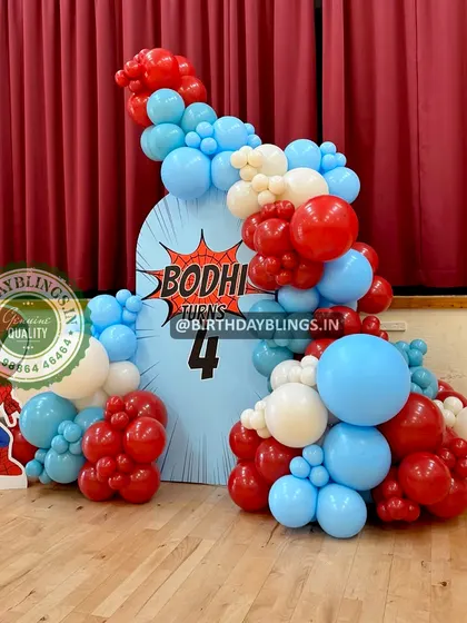 A simple and effective Spider-Man theme, with a character cutout and a balloon arch in the hero's signature colors. The backdrop features a comic-style "Bodhi turns 4" graphic.