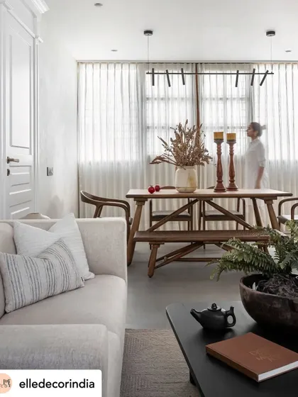 This living and dining area, featured in Elle Decor, interprets Kerala’s heritage with a contemporary eye. We pared back details to let the refurbished wood accents bloom, infusing the home with earthiness.