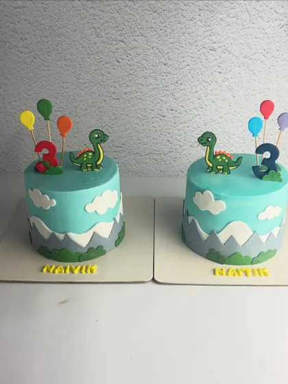 Double the trouble, double the fun! These identical dinosaur-themed cakes were for a set of twins turning three. One was Vanilla Blueberry and the other Vanilla Caramel.