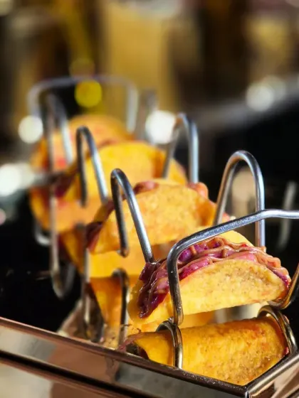 Our Mexican tacos are lined up and ready for service. We use custom taco holders to ensure they are presented beautifully and are easy for guests to pick up and enjoy.