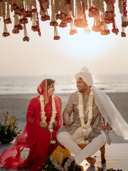 A moment of pure joy between the couple at their sunset wedding in Goa. The golden light, the sound of the waves, and the traditional floral decor created a truly magical 'ehsaas' (feeling).