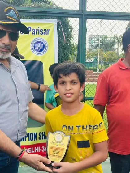 Garvit Gupta receiving his second-place award for the Under-8 category at the DDA Tennis Tournament. Every tournament is a valuable learning experience.
