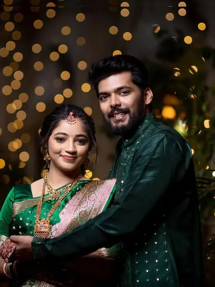 A lovely portrait of the happy couple smiling for the camera during their engagement ceremony.